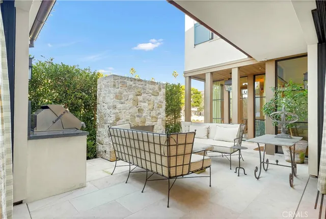 a view of a porch with furniture and floor to ceiling window