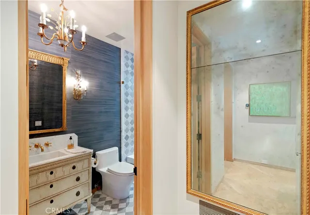 a bathroom with a toilet a sink and a mirror