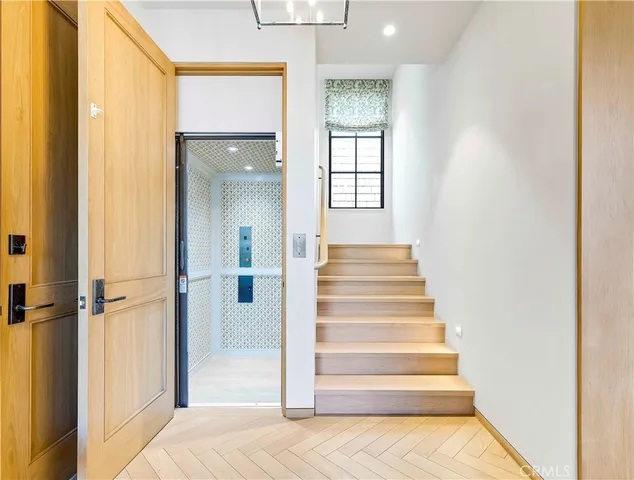 a view of entryway and hall with wooden floor