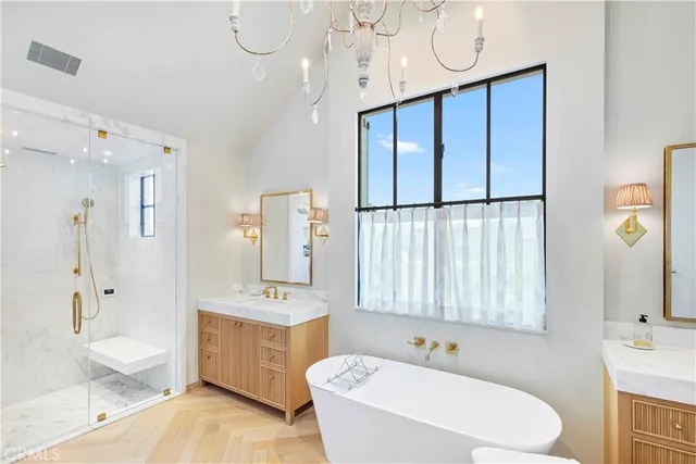 a bathroom with a sink a tub and a mirror