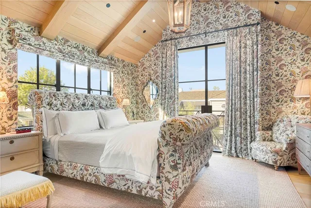 a bed sitting in a bedroom next to a window