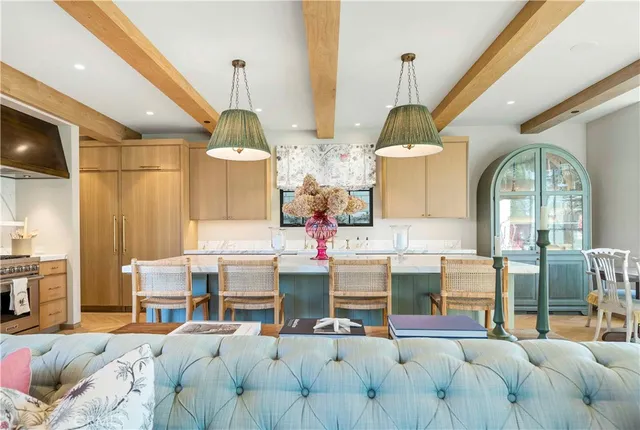 a living room with furniture chandelier and fireplace