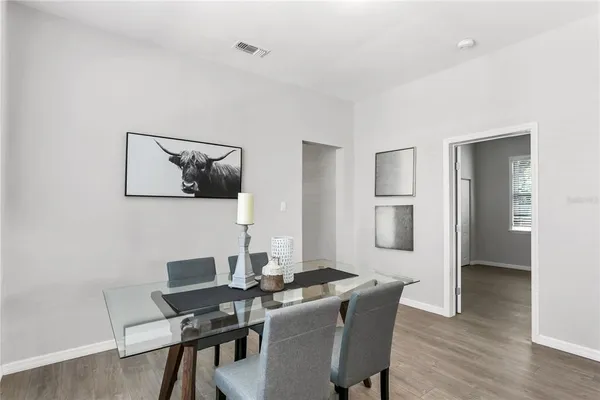 a view of a dining room with furniture and wooden floor