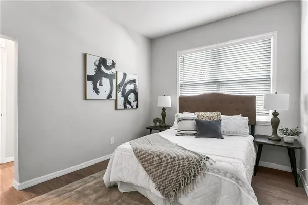 a bedroom with a bed and a window