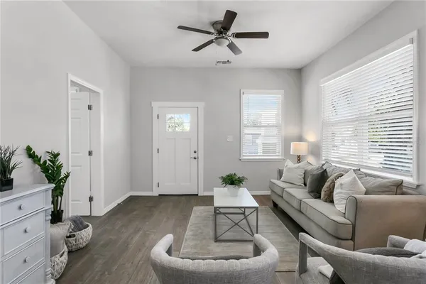 a living room with furniture potted plant and window