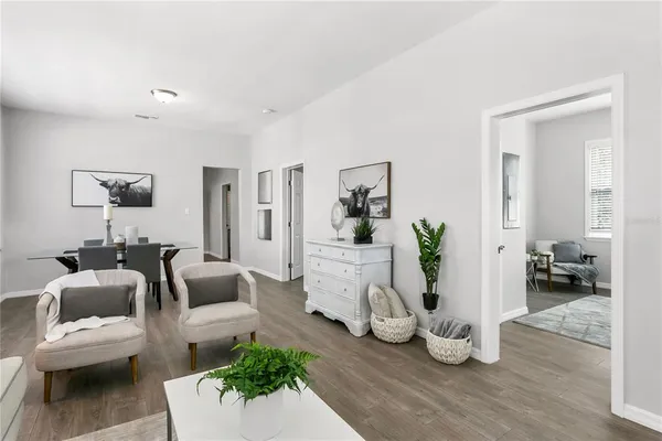 a living room with furniture and wooden floor