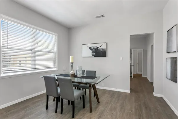 a view of a dining room with furniture and wooden floor