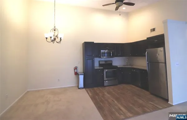 a kitchen with a refrigerator and cabinets