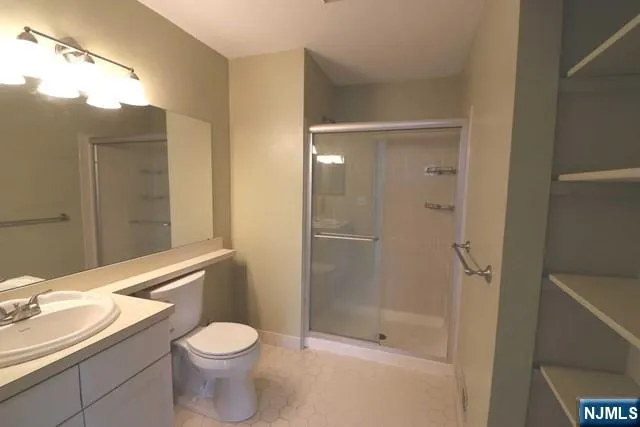 a bathroom with a toilet a sink and shower