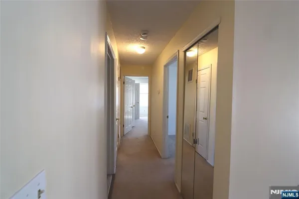 a view of hallway with a mirror