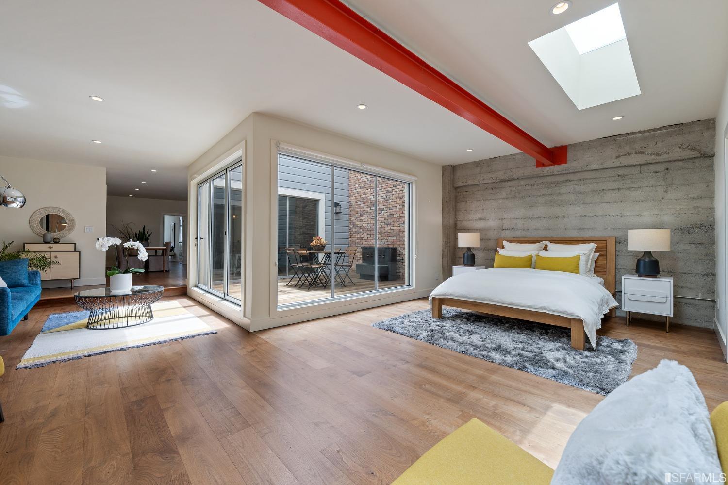 a bedroom with a bed and glass door