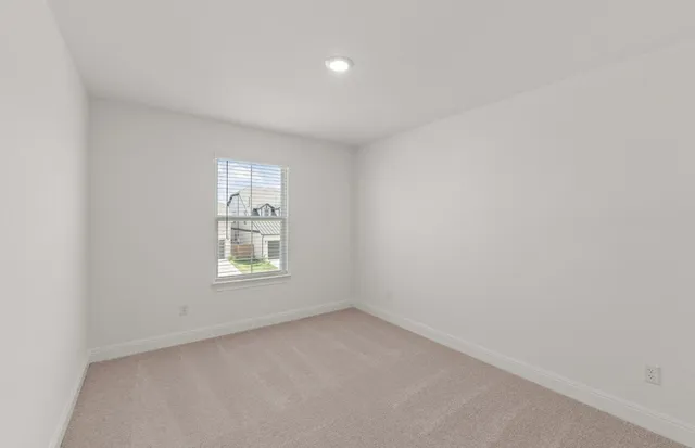 a view of room with a ceiling fan and window