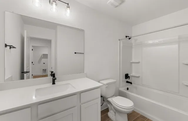 a view of a kitchen with a refrigerator and a window