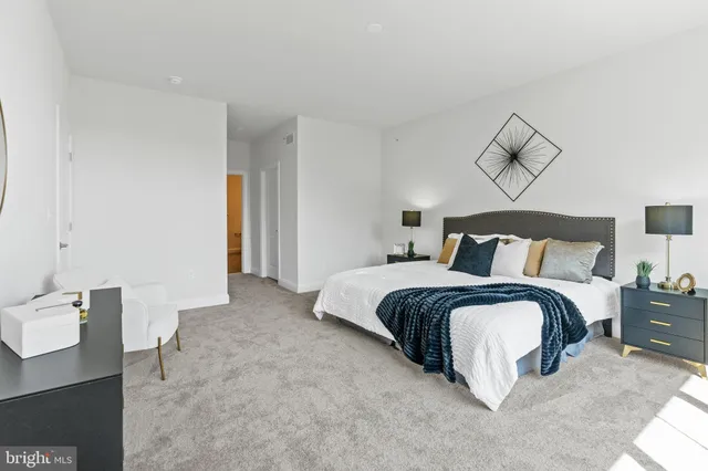 a bedroom with a bed and a lamp