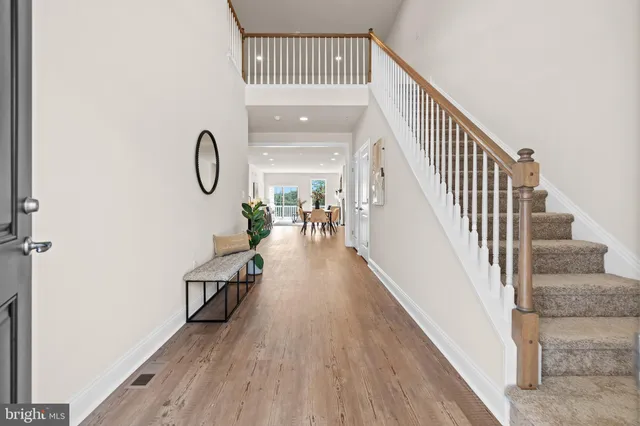 a view of entryway and hall with wooden floor