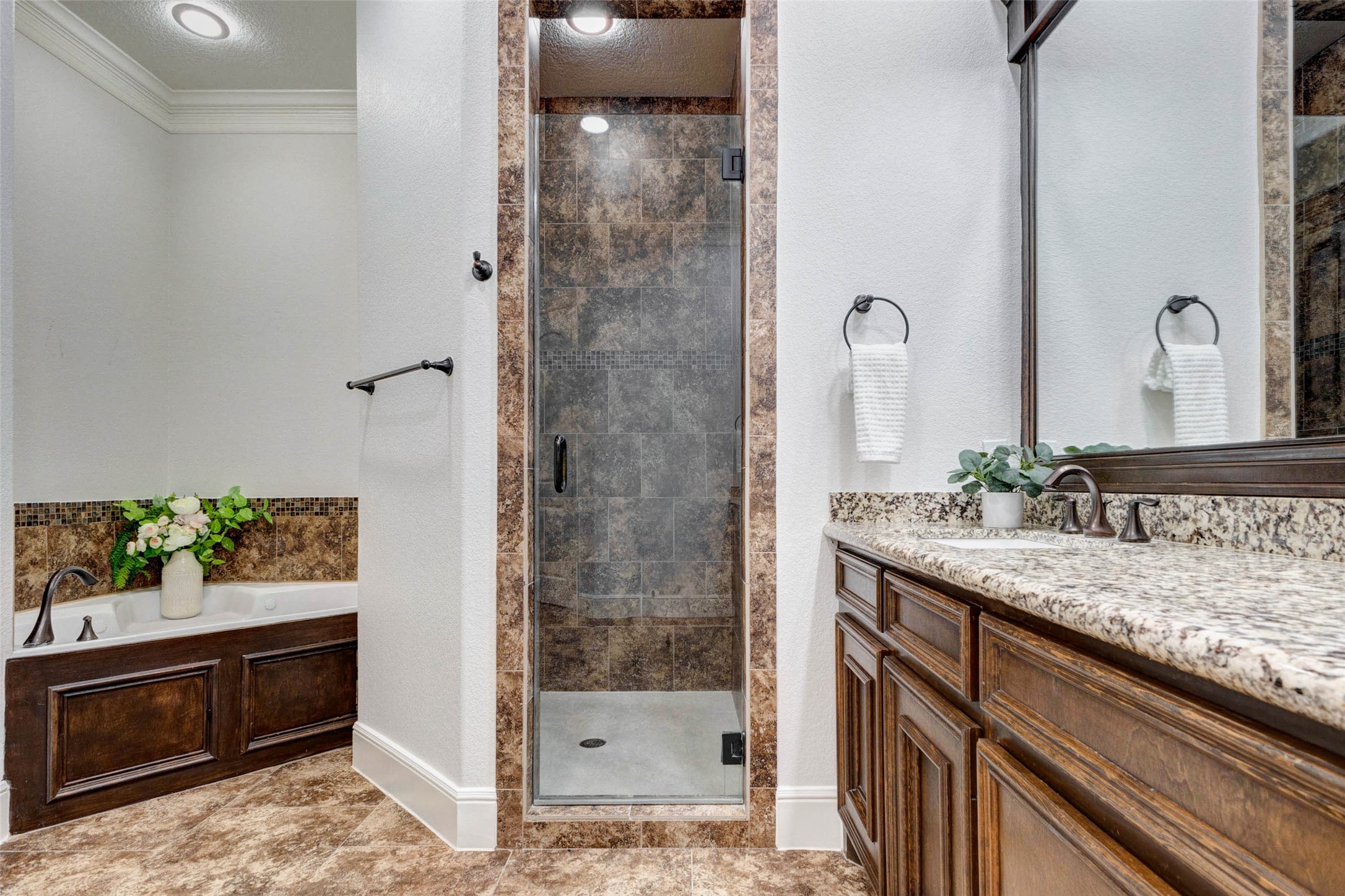 5327 Whitmore Fulshear, TX 77441 - Photo 26 of 50 Relax and unwind in the luxurious ensuite bath featuring a whirlpool soaking tub, oversized jetted shower, and elegant finishes throughout. The jetted whirlpool tub provides the perfect place to relax after a long day and serves as a true centerpiece of the primary bath.