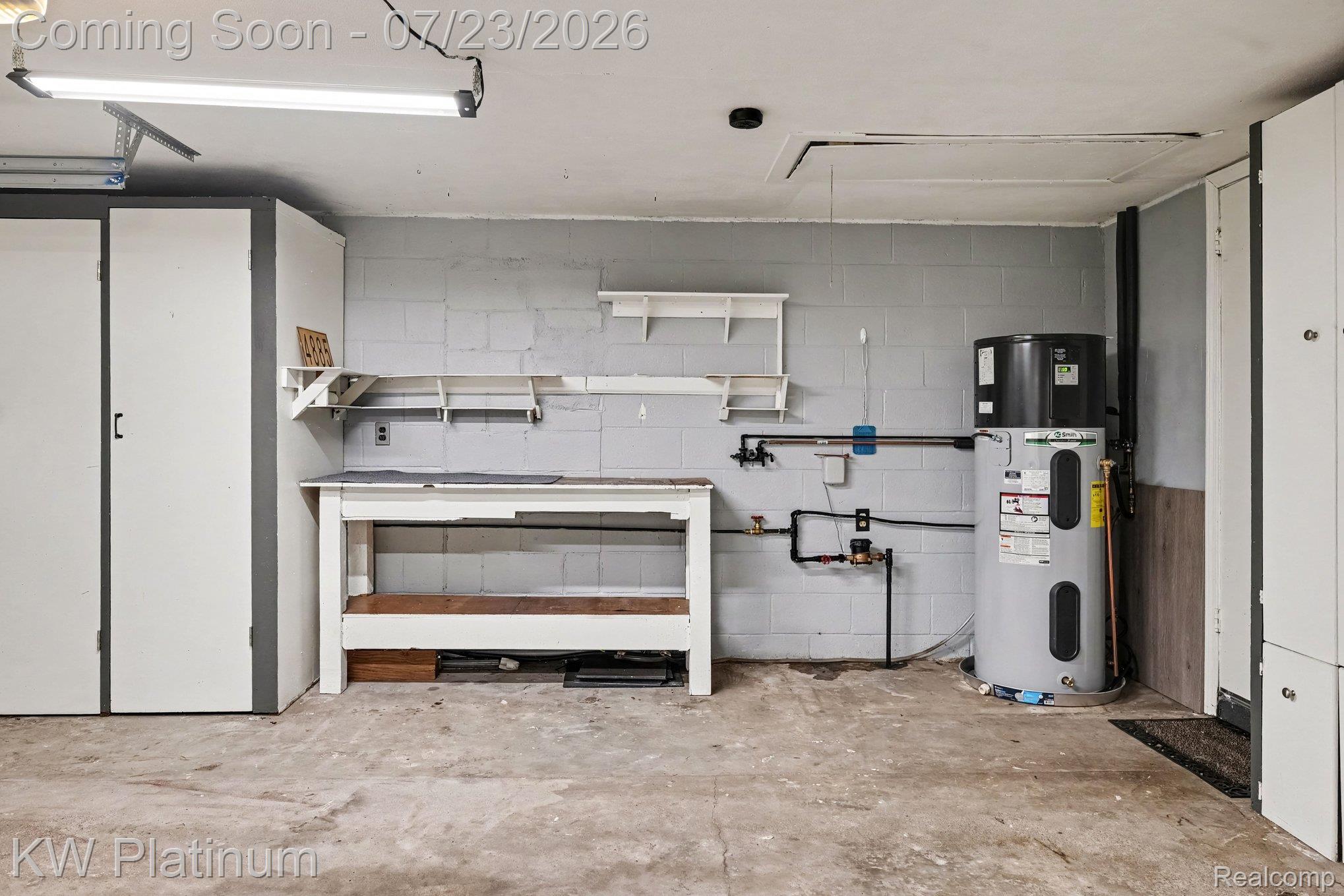 4885 Lakeshore Road Fort Gratiot, MI 48059 - Photo 19 of 26 Garage interior with concrete flooring and exposed cinder block walls