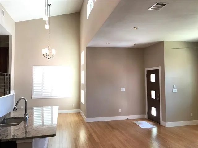 a view of a livingroom with wooden floor and a window