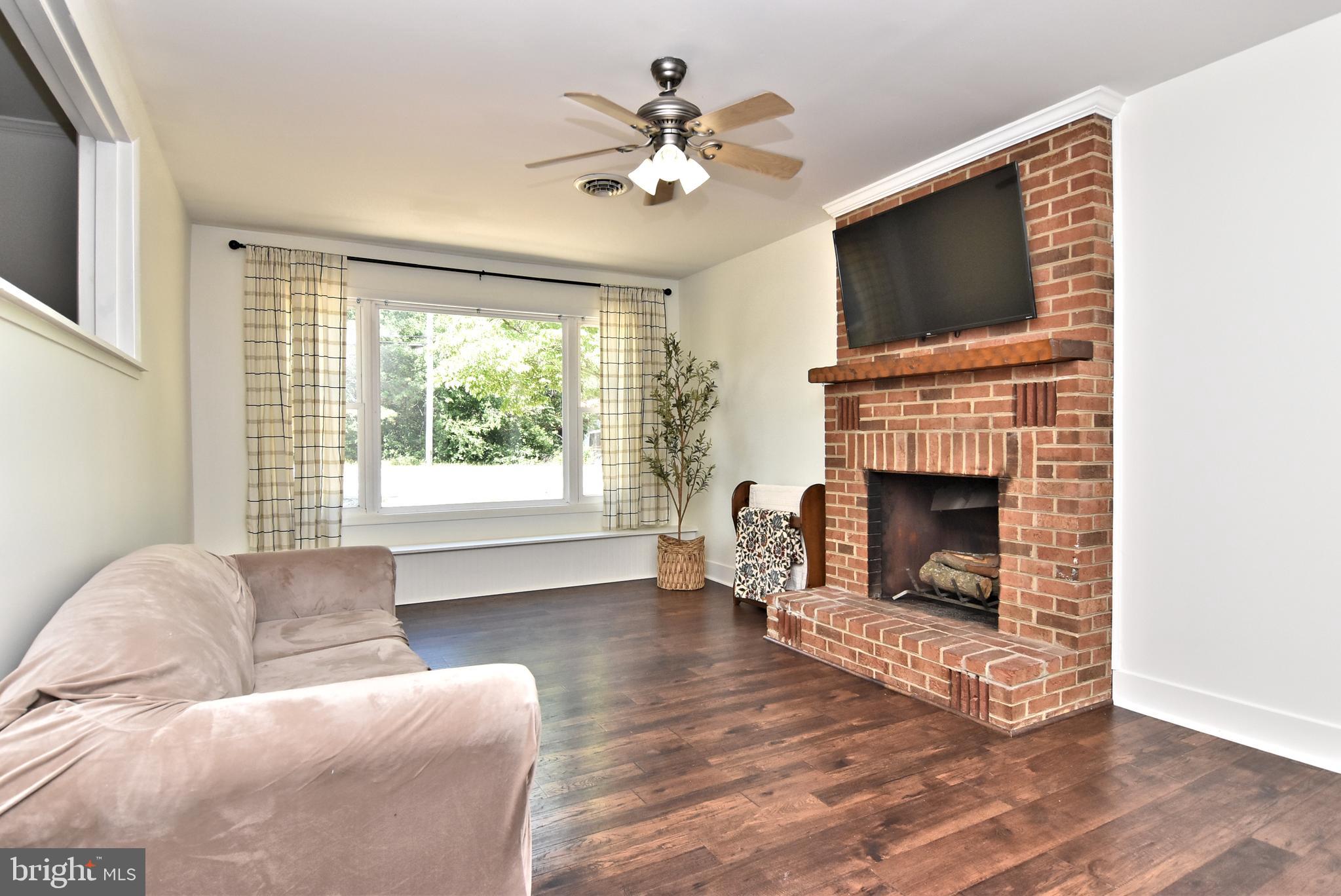 9012 Concord Road Seaford, DE 19973 - Photo 12 of 24 a living room with furniture a fireplace and a flat screen tv