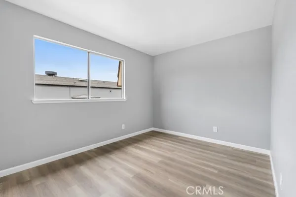 a view of a room with wooden floor and fan