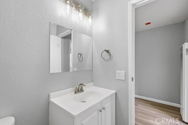 a bathroom with a sink a toilet and mirror