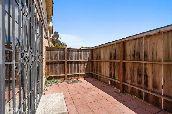 a view of a balcony with wooden fence