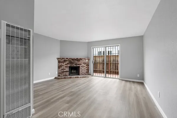 wooden floor in an empty room with a fireplace