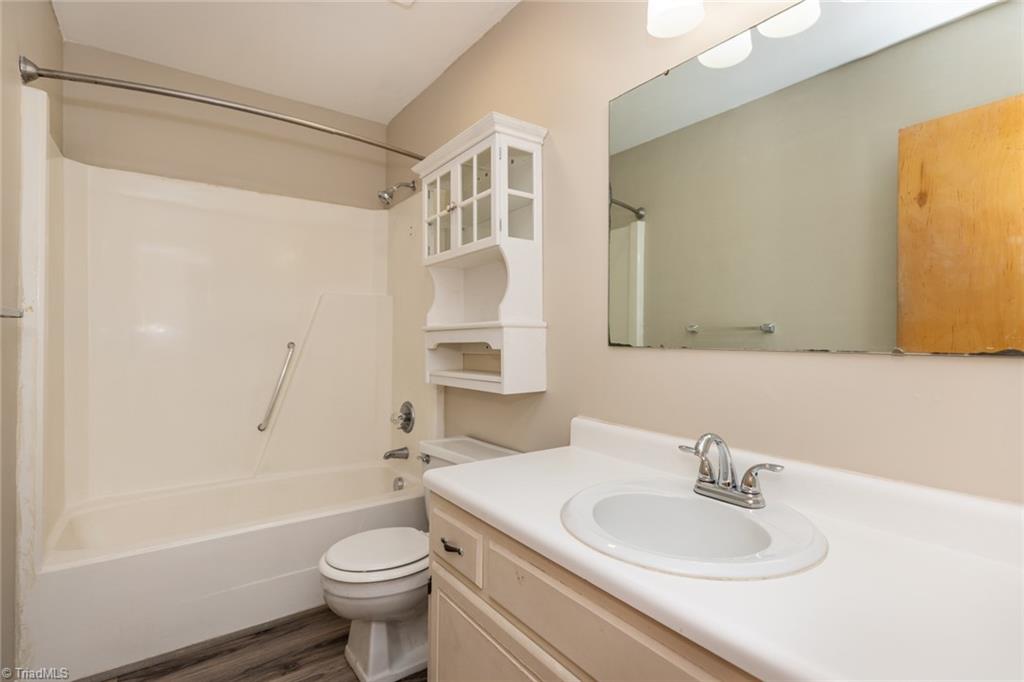 314 Spring Street Thomasville, NC 27360 - Photo 23 of 32 Full bath has new faucet, shower head and shower drain and new exhaust fan with light.