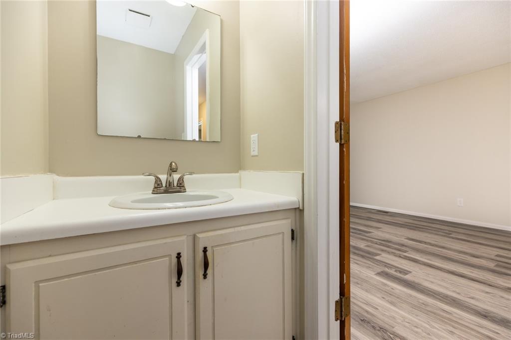314 Spring Street Thomasville, NC 27360 - Photo 25 of 32 Half bath has new faucet, new exhaust fan and good vanity storage.
