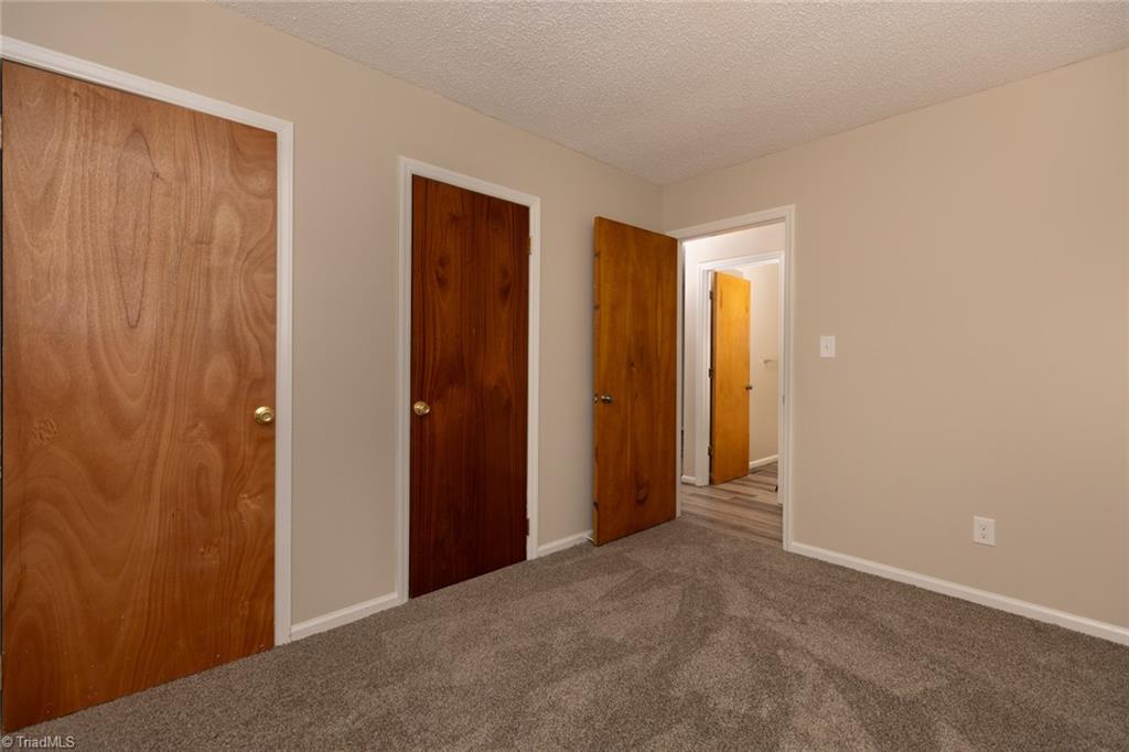 314 Spring Street Thomasville, NC 27360 - Photo 28 of 32 Second of the three bedrooms has 2 nice sized closets.