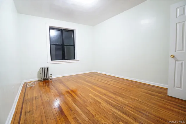 a view of a room with wooden floor and a sink