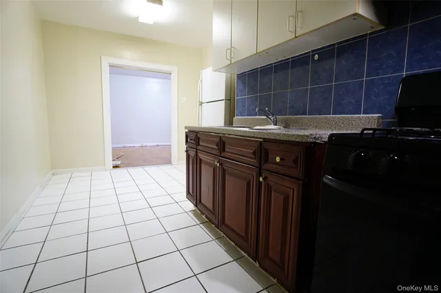 a kitchen with a sink a stove and cabinets