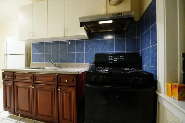 a kitchen with a stove and a cabinets