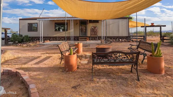 a view of a patio with table and chairs with wooden floor and fence