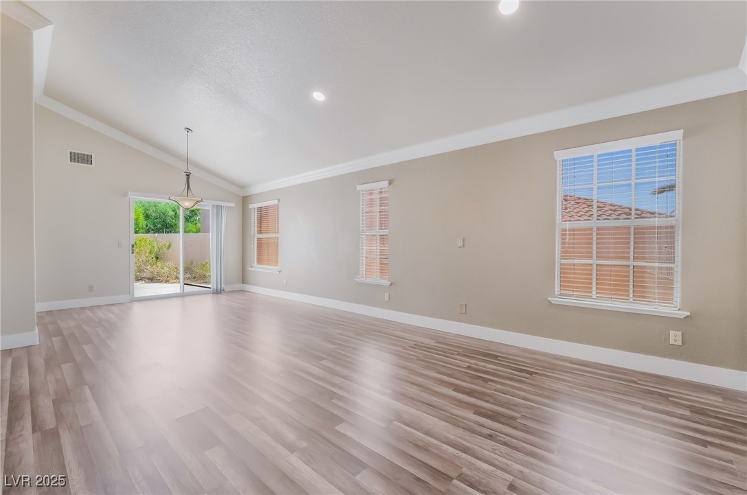 1804 Michaels Court Henderson, NV 89014 - Photo 1 of 44 Unfurnished living room featuring vaulted ceiling, light wood-style flooring, recessed lighting, and crown molding