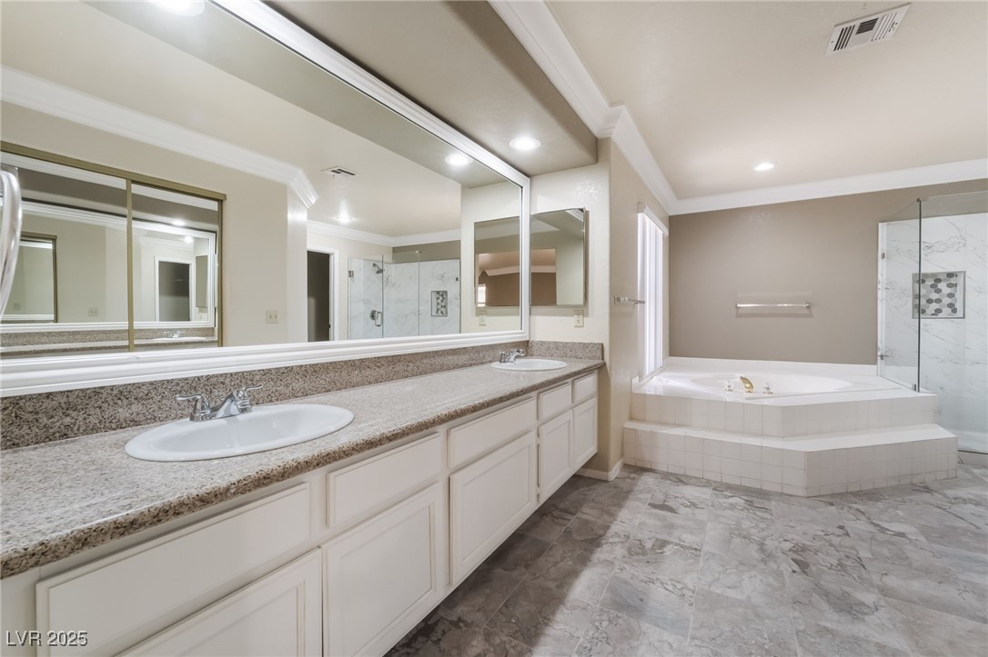 1804 Michaels Court Henderson, NV 89014 - Photo 17 of 44 Bathroom with crown molding, a garden tub, a shower stall, and double vanity