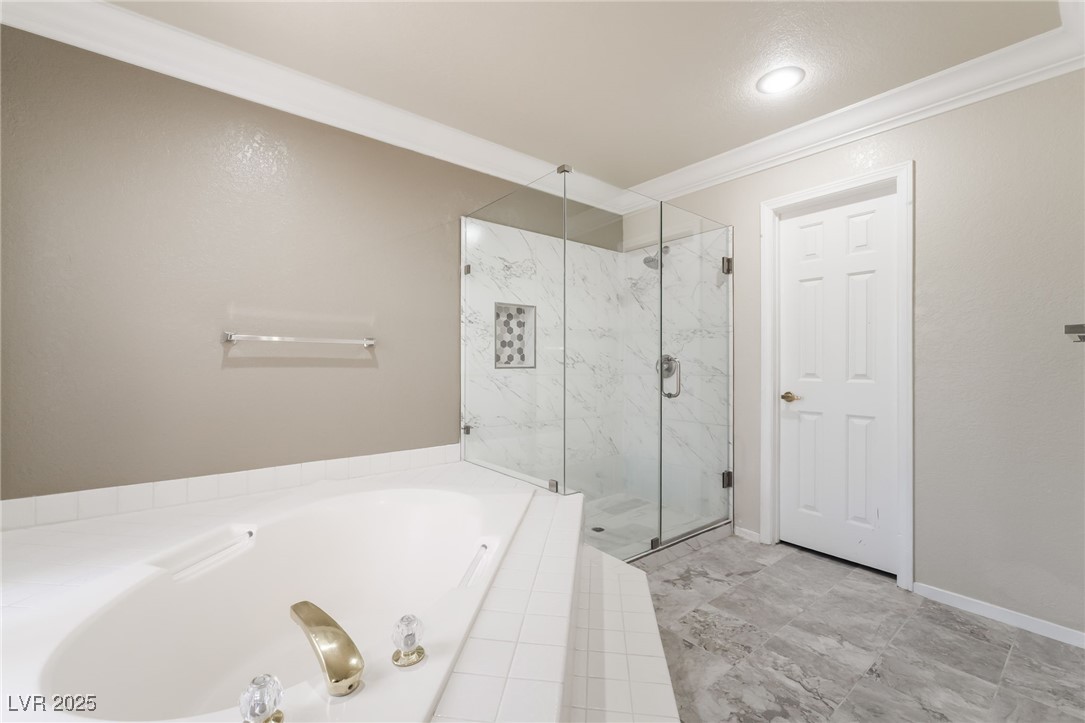 1804 Michaels Court Henderson, NV 89014 - Photo 18 of 44 Bathroom featuring a garden tub, a marble finish shower, ornamental molding, and recessed lighting
