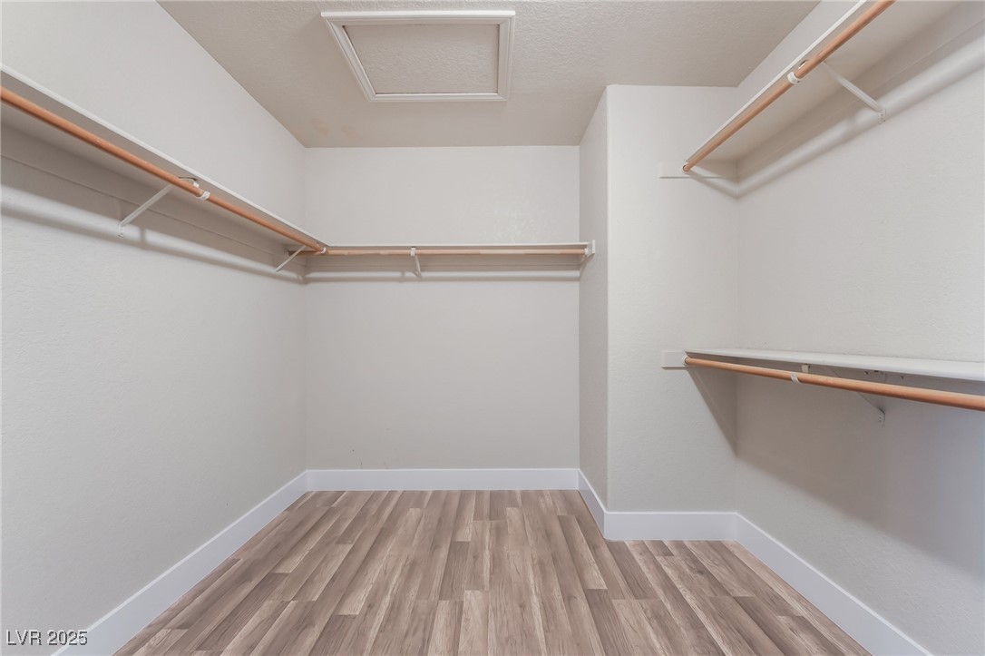 1804 Michaels Court Henderson, NV 89014 - Photo 21 of 44 Walk in closet featuring attic access and wood finished floors