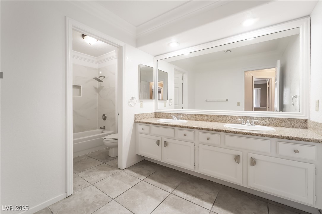 1804 Michaels Court Henderson, NV 89014 - Photo 24 of 44 Bathroom featuring double vanity, tile patterned floors, tub / shower combination, and crown molding