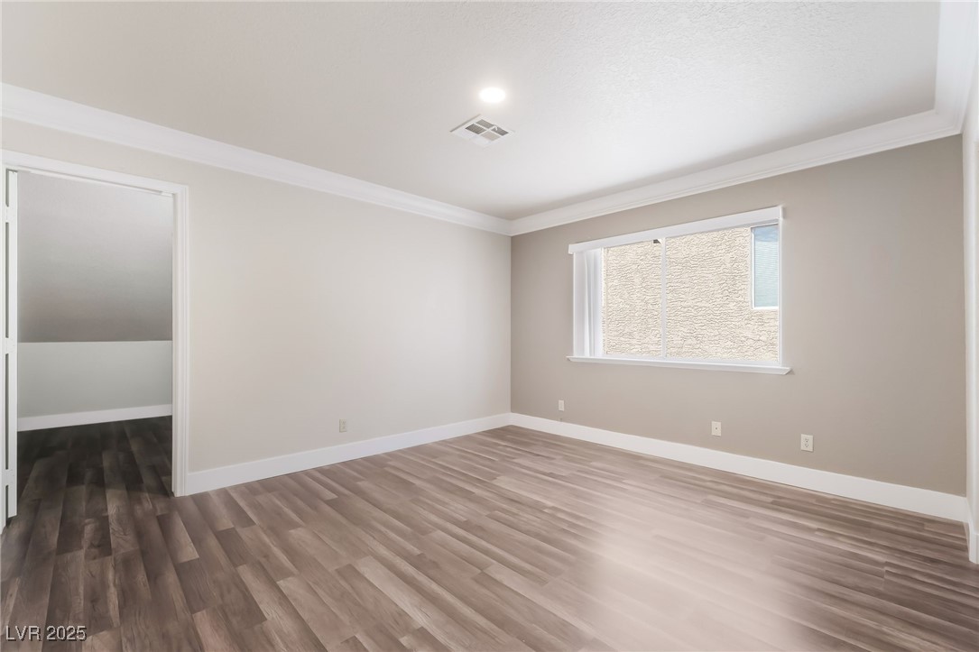 1804 Michaels Court Henderson, NV 89014 - Photo 28 of 44 Unfurnished room with crown molding and dark wood-style flooring