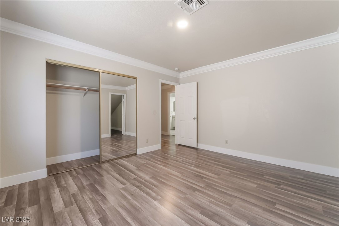 1804 Michaels Court Henderson, NV 89014 - Photo 29 of 44 Unfurnished bedroom featuring ornamental molding, wood finished floors, and a closet