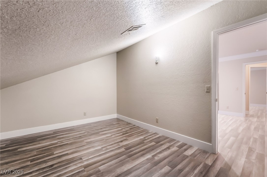 1804 Michaels Court Henderson, NV 89014 - Photo 30 of 44 Bonus room with wood finished floors, a textured ceiling, and a textured wall