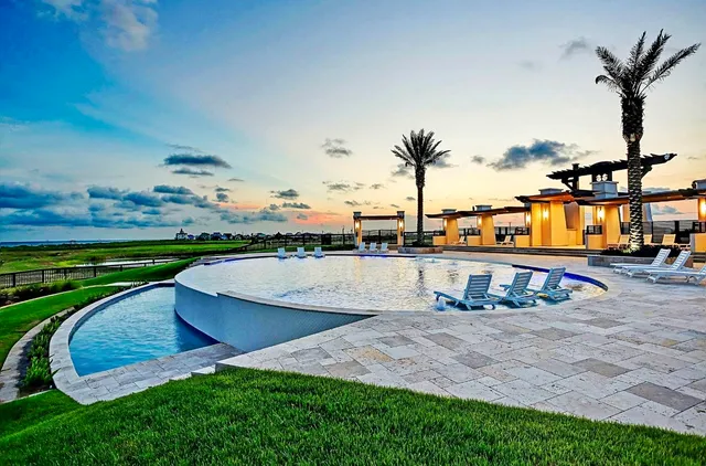 an outdoor space with swimming pool and furniture