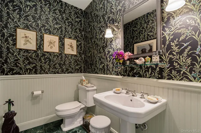 a dining room with furniture a chandelier and wooden floor
