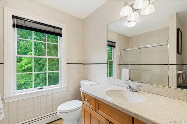 a bedroom with a bed chair and a window