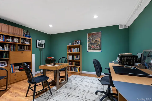 a view of a livingroom with wooden floor and furniture