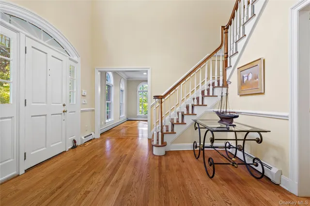 a view of entryway with wooden floor and stairs