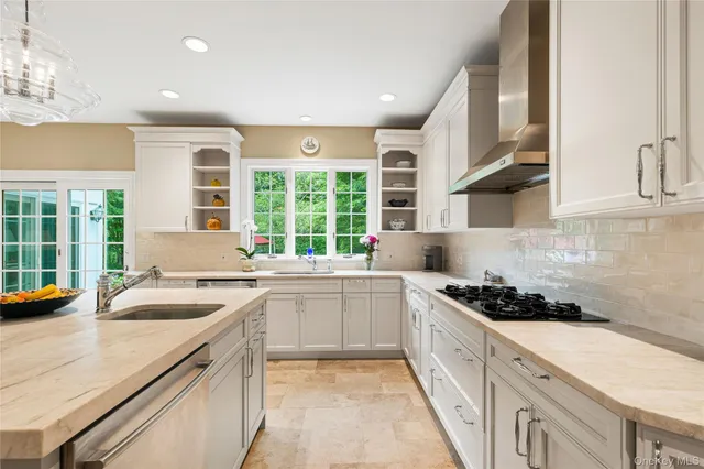 a kitchen with stainless steel appliances granite countertop a sink and cabinets