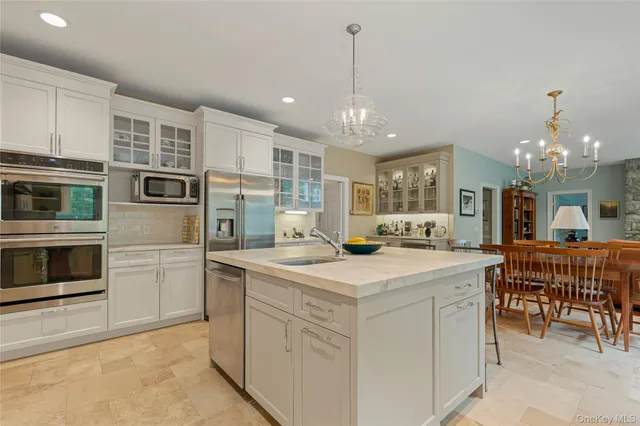 a kitchen with stainless steel appliances granite countertop a sink stove and cabinets