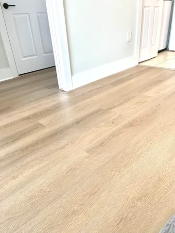 a view of wooden floor with a book shelf